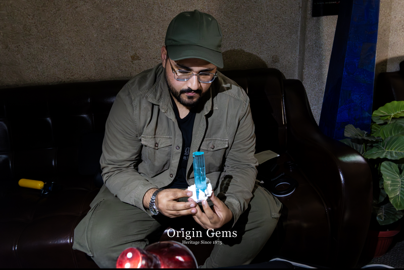 Holding a large aquamarine gemstone high quality mined from Shigar valley near Skardu Pakistan in Namak Mandi