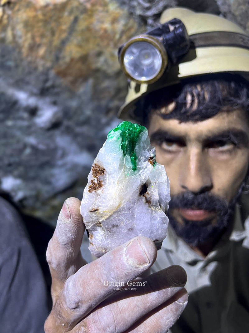 An Emerald miner in Swat Valley Mingora holding an Emerald deep underground.